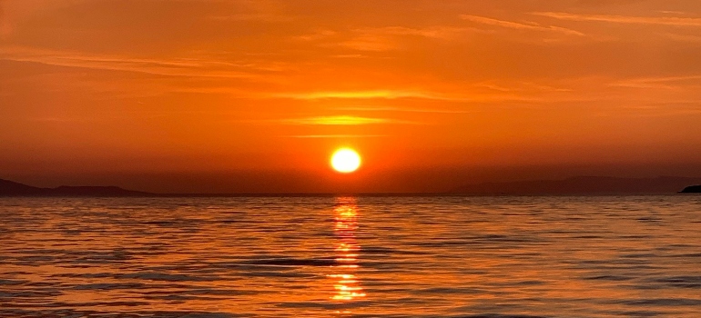 A sunrise over a calm landscape.