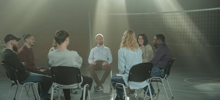 People on group therapy talking about the myths about faith-based addiction treatment programs