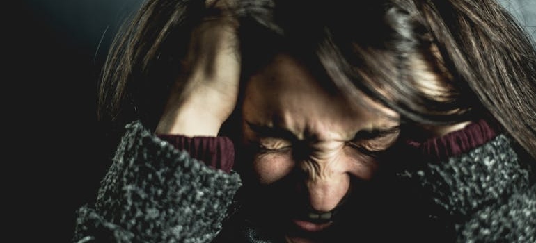 A woman holding her head