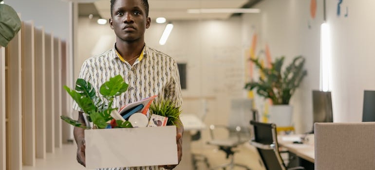 A man holding a box thinking about how substance abuse is impacting communities across Virginia