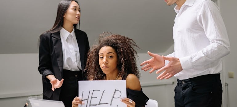 A woman holdinh help sign