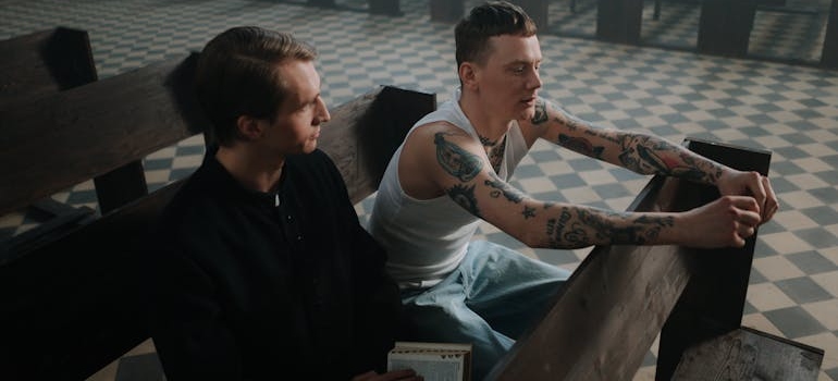 A priest and a man talking about how churches can support people in recovery