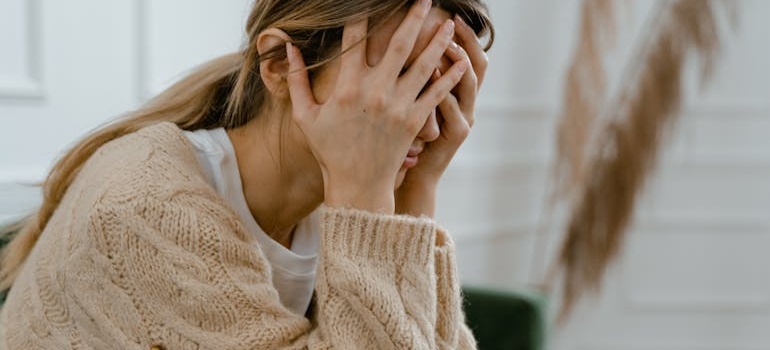 A woman holding her head