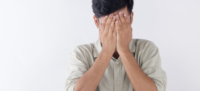A person covering his face