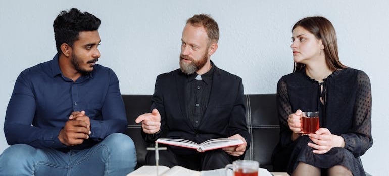 Three people talking about how churches can support people in recovery