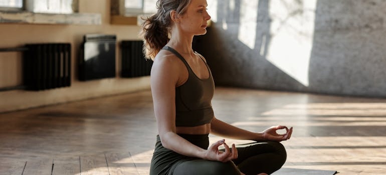 A woman meditating and thriving in sobriety