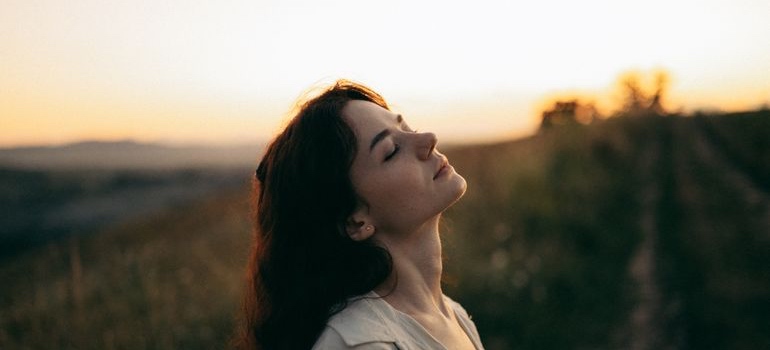 Person standing outdoors at sunset