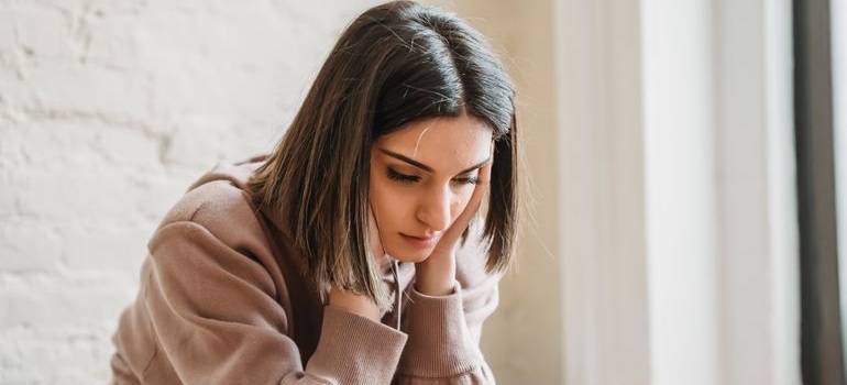 Person sitting alone and looking distressed